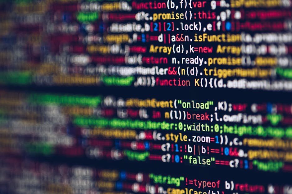 A close-up image of a computer screen displaying lines of multi-colored programming code, featuring keywords, variables, and functions in shades of red, blue, green, yellow, and white on a dark backgr